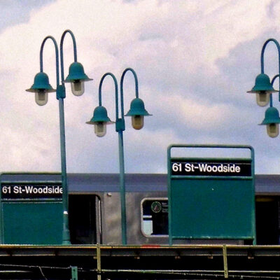 This is an image of a 61st St Woodside Subway Station Sign