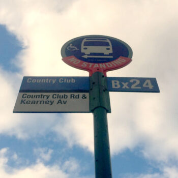 This is an image of a Country Club Bus Stop Sign