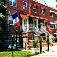 This is an image of Morris Park Homes With New York State and AmericanFlags