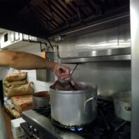 This is an image of A chef Cooking Squid At Patricias Restaurant in Morris Park