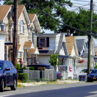 This is an image of Throggs Neck Houses with flags